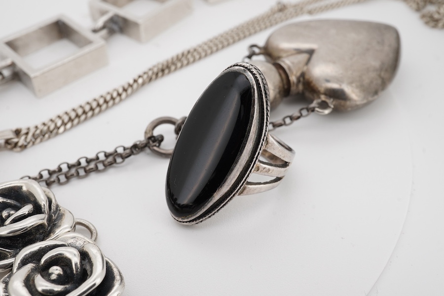 A Danish Hans Hansen 925 square link bracelet, 19.2cm, together with an modern engraved silver oval locket on a 925 chain, a 925 ring, a 925 flower head link bracelet and a modern heart shaped scent flask on chain. Condi